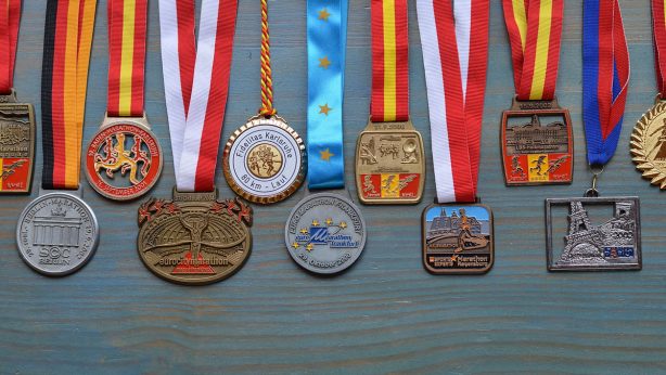 Medals on cyan wooden background