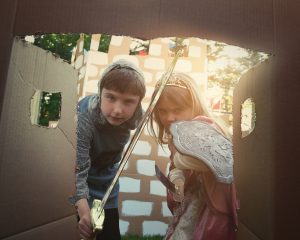 Two children pretending to be knights.